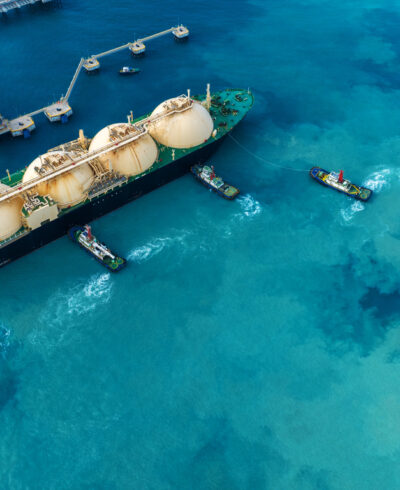 LNG (Liquefied natural gas) tanker anchored in Gas terminal gas tanks for storage. Oil Crude Gas Tanker Ship. LPG at Tanker Bay Petroleum Chemical or Methane freighter export import transportation